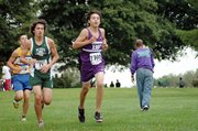 Baldwin High School sophomore Tosh Mihesuah, center, placed seventh in a time of 18:08.25. He was the third Bulldog across the finish line.