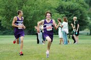 Baldwin High School junior Tony Weiss, right, sprints to the finish while sophomore Brian Wright looks off in the direction of the spectators. Weiss won the 5-kilometer race while Wright finished runner-up as the Bulldogs placed second as a team.