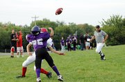 Baldwin Junior High School eighth grader Cornell Brown, front, leaps over an Ottawa defender to catch a touchdown pass from Chad Berg during the second quarter Tuesday.