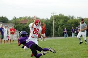 Baldwin Junior High School eighth grader Cornell Brown, front, concentrates on the ball as he catches the Bulldogs' winning touchdown pass Tuesday.
