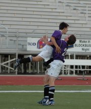 Baldwin High School sophomore Caleb Michaels, left, jumps into senior Brandon Baltzell's arms after scoring the game-winning goal Monday evening.