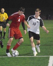 Tonganoxie senior defender Keaton Schaffer moves the ball away from Maranatha Academy's Connor Emberlin on Thursday during the Chieftains' 3-0 loss to the Eagles.