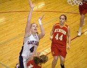 Eudora's Evan Folks is called for a charge on a layup attempt in the first quarter against Atchison on Thursday at the Tonganoxie Invitational. Folks scored 14 points in a 58-33 EHS victory.