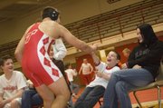 Tonganoxie High sophomore wrestler Jonas Myers high-fives Shane Lewis, a Tonganoxie Elementary School second-grader, after winning a match on Feb. 4. The two became friends through the THS “Leadership in Sports” class, which sends its students to the elementary school weekly.