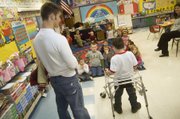 Students in Tiffany Parker’s kindergarten class listen attentively as Tonganoxie Elementary School second-grader Shane Lewis introduces them to his friend Jonas Myers, a Tonganoxie High sophomore. Myers works with Shane each week at TES through the THS “Leadership in Sports” class.