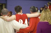 Keaton Schaffer heads toward the exit with the help of Tonganoxie High athletics director Brandon Parker and his grandfather, Dave McKee. Schaffer left at halftime after injuring his back in the first quarter of the Chieftains' 64-61 loss to Pleasant Ridge in a sub-state semifinal at Hoyt.