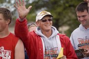 Longtime Tonganoxie Middle School boys track coach Phil Jeannin waves to some of his former athletes in the Beatty Field stands on April 26 during a special ceremony at a TMS track meet. Jeannin, who is retiring, coached his final home meet Monday and was recognized for his 37 years of service at the middle school.