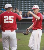 THS assistant coach Mitch Loomis greets Chieftains starting pitcher Brandon Yoder with a fist bump after Yoder worked out of a bases-loaded jam against Bonner Springs in the fifth inning Friday at CommunityAmerica Ballpark.