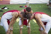 DJ Lindsay, Bret Koch and Jeremy Carlisle share a few moments together after finishing the 4x400 relay race Saturday at Cessna Stadium in Wichita.