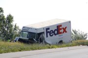 A Federal Express truck involved in a two-car accident Thursday morning, Aug. 19, 2010, on westbound Kansas Highway 10 near De Soto rests off the shoulder of the highway. The truck was struck nearly head-on approximately 8 a.m. by a Ford Escort that crossed the median from the eastbound lane. The female driver of the Escort was killed and the male driver of the truck was transported to an area hospital for injuries, including a broken leg. Kansas Highway Patrol expects the section of westbound K-10 to remain closed until at least noon.