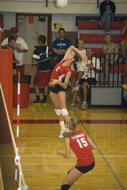 Jenny Whitledge hangs in the air, waiting to swing against Lansing on Tuesday night. The Chieftains lost to the Lions, 25-22, 25-21.