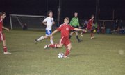 Matt Saathoff takes a big swing at the ball in the second half of Tonganoxie's playoff win at Perry on Monday.