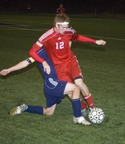 THS sophomore Zack Tallent maintains possessioin of the ball in a regional final loss to Maur Hill-Mount Academy on Friday night in Atchison.