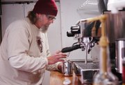 Brian Jurgens of Shawnee-based E.F. Hobbs Specialty Coffee prepares a coffee drink inside CoffeeCakeKC, a mobile truck that sells Jurgens' coffee and Shawnee resident Renee Kloeblen's cupcakes.