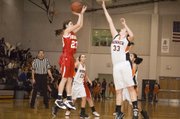 Tonganoxie sophomore forward Jenny Whitledge puts up a jumper as Bonner Springs junior Erica Wilson contests the shot in the second half of the Braves' 59-45 win on Tuesday.