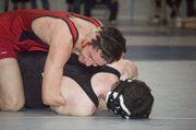 Caleb Himpel, Tonganoxie 130-pounder, holds down his opponent in a consolation semifinal victory Saturday at the Class 4A regional at Holton. Himpel earned a trip to state with the win.