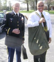 World War II veteran Nelson Borden, left, and Trailridge Middle School Principal Larry King carry artifacts into the school last Tuesday before eighth-grade social studies students interviewed Borden and eleven other veterans.