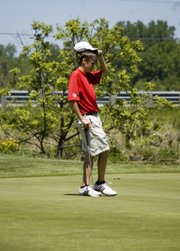 Tonganoxie High freshman golfer Drew Sandburg examines the green before putting on Monday at Dub’s Dread Golf Club, in Kansas City, Kan. Sandburg finished with an 85 at a Class 4A regional tournament, helping the Chieftains finish second in the team standings and earn a trip to the state tournament. Sandburg was one of four THS golfers to score 85 or lower and finish in the top 11 on the leaderboard.