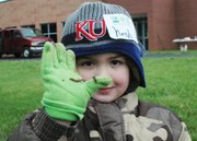 Noah Randall shows off a worm he found in the Bluejacket-Flint rain garden. Noah will be a kindergartener next year.