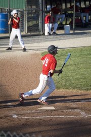 Tonganoxie's Amos White tracks the path of the ball he just hit in Post 41's 8-6 loss to Wellsville on July 19 at Kansas City, Kan.