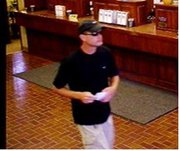 The FBI believes this man — captured on surveillance video prior to donning a disguise — may be responsible for a July 25 bank robbery in Shawnee, as well as four Oklahoma heists and one in Joplin, Mo.