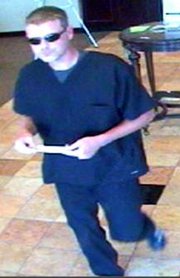 The FBI believes this man — captured on surveillance video prior to robbing an Olathe bank on Aug. 3 — is responsible for a July 25 bank robbery in Shawnee, as well as four Oklahoma heists and one in Joplin, Mo. The serial bank robber typically enters the banks shortly before the robbery, changes into a disguise with a fake beard, then returns to the bank to rob it, according to the FBI.