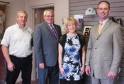 Pictured from left: Tom Ohmes, Gregg Amos, Anne Smith and Mark Smith of The Amos Family Funeral Home. Anne Smith is the pet cremation consultant for the funeral home's Amos Family Pet Companion Crematory. Ohmes performs nearly all of Amos' pet cremations.