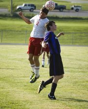 Tonganoxie High senior Cody Martin heads the ball forward during the second half of the Chieftains season opener on Friday. THS tied Baldwin, 1-1.