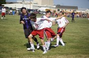THS teammates Evan Stilgenbauer and Tyler Bartholomew nearly collide while going after the ball in the air on Friday against Baldwin. The match ended in a 1-1 tie.