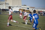 Tonganoxie sophomore Evan Stilgenbauer chases down the ball as it bounces near the top of the box in the first half of the Chieftains' 4-0 home win against Perry-Lecompton on Monday.