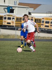 THS junior captain Zack Tallent pushes the ball up the field for Tonganoxie in the first half of the Chieftains' 4-0 hom win on Monday versus PLHS.