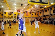 Baldwin High School junior Katie Kehl puts up a guarded shot along the baseline Tuesday. Kehl scored nine points to help the Bulldogs beat rival Paola 56-47.