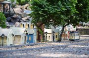 A streetcar makes past a row of buildings in the railroad town Jim Neighbor painstakingly created in his backyard.