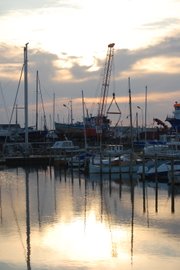 The light from the setting sun shines on the calm waters of the Gilleleje Harbor in this photo taken by Riley Mortensen, Bonner Springs High School graduate.
