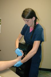 Kelsey Wagner scans the foot of a patient at Mid Star Lab. The scans are used to create a wooden replica of the foot.