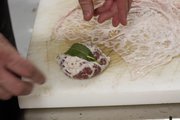 Michael Beard, executive chef at 715 restaurant, 715 Mass. in Lawrence, prepares an appetizer of fegalo, an Italian-style liver sausage wrapped in caul fat.