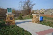 The Clear Creek pedestrian and biking trail, shown heading west of Woodland Drive in this photo, will soon tie into the 17-mile-long Mill Creek Streamway Park trail.