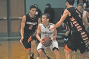 BSHS junior Zshavon Dotson (2) guards BLHS junior J.P. Downing during Tuesday’s 65-48 Bobcats victory. Downing added nine points in the game as the Bobcats handed the Braves their second straight defeat.