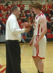 Dane Erickson is congratulated by coach Shawn Phillips after scoring his 1,000th point on senior night.