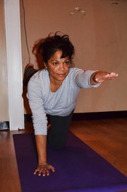 Carla Mason leads her restorative yoga class in a stretching and balancing exercise at the Inner Wisdom Wellness Center, 5807 Merriam Drive.