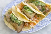 This recipe for fish tacos calls for lightly flouring and sauteeing fish instead of deep-frying it, then topping it with buttermilk avocado puree instead of a mayonnaise-based sauce.
