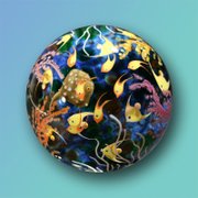 This piece by Cathy Richardson is called the "Many Fish Reef" and is about 2.5 inches in diameter. It was made by “drawing” on multiple layers of hot glass from a furnace with molten colored glass rods.