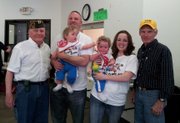 Vic Tranckino and Karla Holton with their family Lance and Blake and the Basehor VFW Post Commander Phil Jenkins and Steve McCown.
