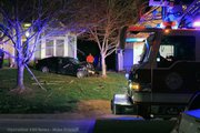 A car crashed through two fences and sideswiped a house before crashing head-on into a tree.