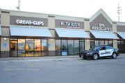 Shawnee Police standing by outside of the Great Clips store at 15943 West 65th Street following an early morning burglary.