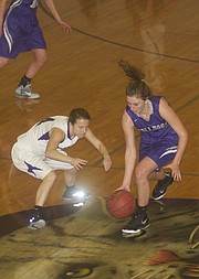 Baldwin senior Maddie Ogle makes a steal in the Bulldogs 44-28 victory Tuesday at Louisburg. The Baldwin defense clamped down on the Wildcats, limiting the home team to just two points in the fourth quarter.