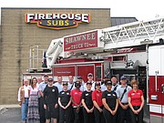 Shawnee Mayor Michelle Distler, City Council Member Jim Neighbor, members of the Shawnee Fire Department, the staff of Firehouse Subs and local franchise owner Robin Heath stand outside of the Shawnee restaurant after the fire department was presented with a $2,000 grant.