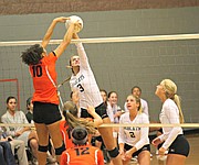 Basehor-Linwood's Madi Osterhaus goes for a kill as Bonner Springs' Julianne Jackson attempts to block.