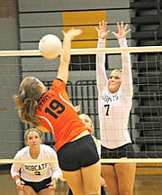 Bonner Springs' Paige Krone (19) goes for a kill as Basehor-Linwood's Courtney Norris attempts to block.