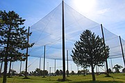 This photo provided by Kansas State University Polytechnic Campus shows the school's new drone testing pavilion for unmanned aircraft systems (UAS). The nets on the 300-foot long, 200-foot wide and 50-foot tall structure allow the wind, rain, snow or other weather conditions to easily pass into the test area and don’t block GPS signals. That means that researchers can test the drones in lifelike situations without risking safety.